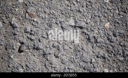 Texture of concrete. Asphalt background. Road surface. Texture of asphalt and stones on the road. Stock Photo