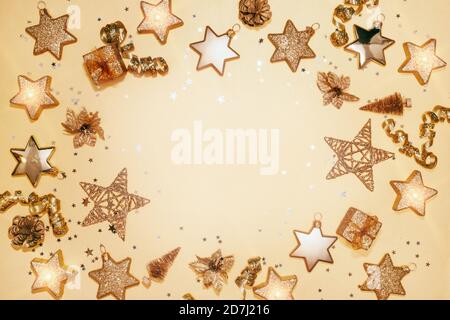 Christmas composition. Christmas balls, stars, gift boxes, ribbons and candles. New year decorations on yellow background. Flat lay, top view, copy space Stock Photo