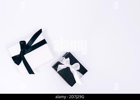 Black and white gift or present boxes on white background. Flat lay composition for birthday, Christmas, wedding. Free copy space for text. Stock Photo