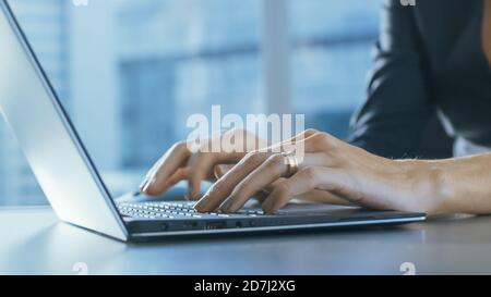 Close-up of the Businesswoman's Hands Typing on a Laptop in Her Office. Stock Photo