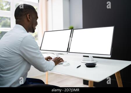 African Manager Working On Corporate Computer With Blank Screen Stock Photo