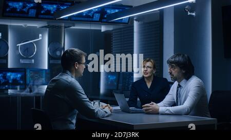 On a Job Interview Two Senior Managers Ask Young Candidate Questions. Secret Service Recruiting Talented Young Man. Serious People Working in Stock Photo