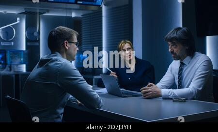 Two Hiring Managers Recruiters Ask Young Applicant Questions on a Job Interview. Secret Service Recruiting Talented Young Man. Agents Questioning Stock Photo