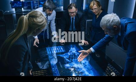 Diverse Team of Corporate Businesspeople Work on Computers and Have Meeting about Logistics of Import Export. Specialists Working on Computers Stock Photo