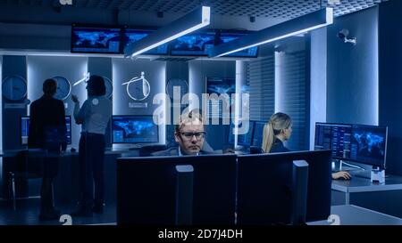 Diverse Team of Corporate Businesspeople Work on Computers and Have Meeting about Logistics of Import Export. Specialists Working on Computers Stock Photo