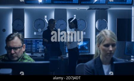 Government Cybersecurity Agency Professionals Working on Personal Computers in Cooperation with Army. Specialists Working on Computers in System Stock Photo