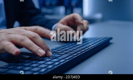 Close-up on the Man's in a Suit Hands Typing on a Keyboard. Stock Photo