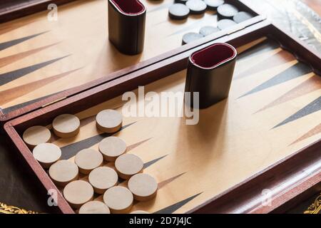 Vintage backgammon table game, clode-up photo with selective focus. This is the one of the oldest known board games Stock Photo