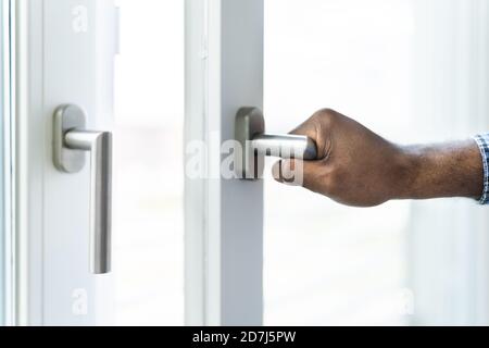 African American Man Opening Office Window Side View Stock Photo