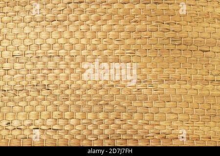 A woven Mat of reeds or straw-yellow in color. The texture of dry cane. Light yellow Stock Photo