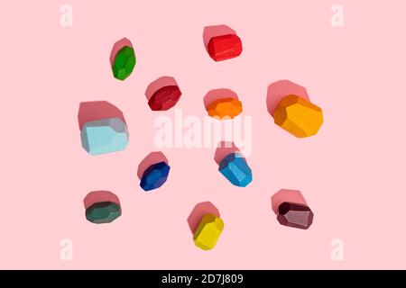 Multi colored wooden blocks against pink background Stock Photo