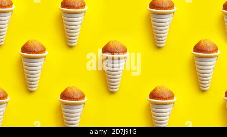 Icecream waffle cone and cupcake pattern isolated on yellow background Stock Photo