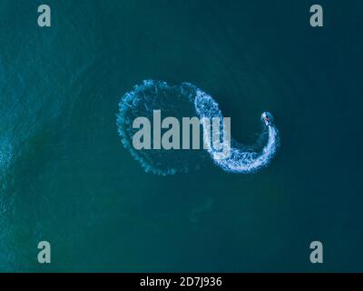 Aerial view of jet boat sailing in turquoise water Stock Photo - Alamy