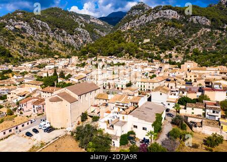 Aerial view of houses in village against mountain range on sunny day, Caimari, Majorca, Spain Stock Photo