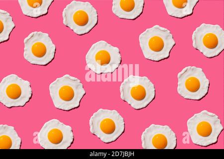 Pattern of fried eggs against pink background Stock Photo