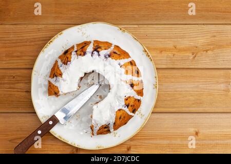 Homemade raspberry cake with white sugar icing on wooden table. Top view. Stock Photo