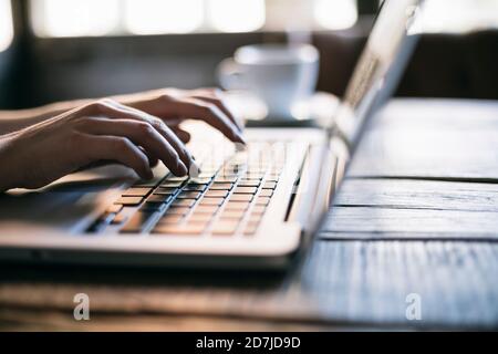 Cropped image of woman hand using laptop in cafe Stock Photo