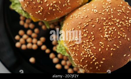 Vegetable Burger with chickpea cutlet. Two burgers on a black plate. Top view Stock Photo