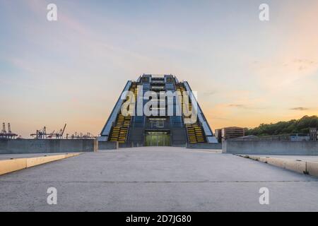 Germany, Hamburg, Illuminated modern office building near dock at sunset Stock Photo