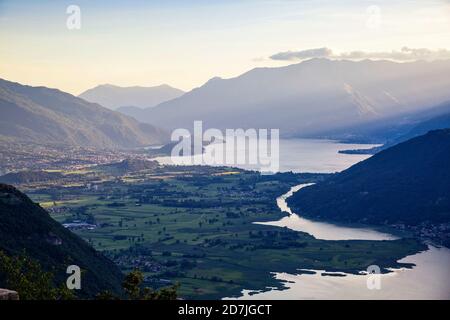 Italy, Province of Sondrio, Scenic view of Lake Mezzola in Riserva Naturale Pian di Spagna e Lago di Mezzola at dusk Stock Photo