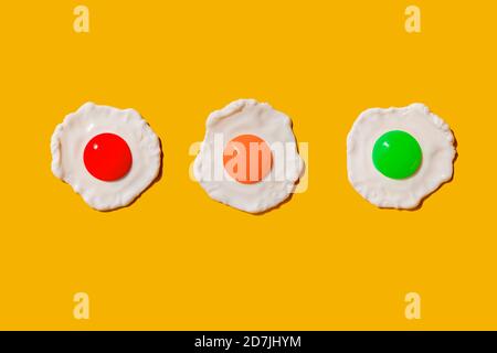 Studio shot of three colorful fried eggs Stock Photo