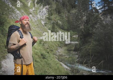 Bearded man wearing bandana standing in forest, Otschergraben, Austria Stock Photo
