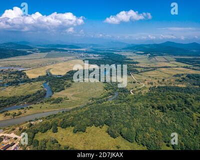 Russia, Primorsky Krai, Nakhodka, Aerial view of river winding through green forested landscape Stock Photo