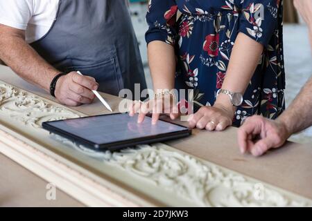Carpenter and designer using digital tablet at workshop Stock Photo