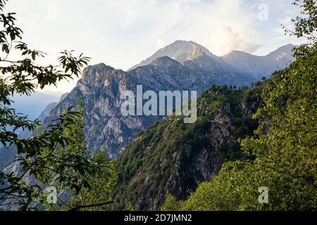 Italy, Province of Sondrio, Mountain range in Riserva Naturale Pian di Spagna e Lago di Mezzola at dusk Stock Photo