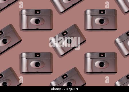 Close-up of retro cameras on pink background