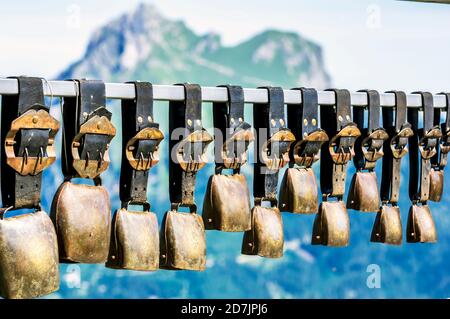 Row of cow bells hanging outdoors Stock Photo