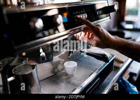 Male barista preparing coffee in cafe Stock Photo