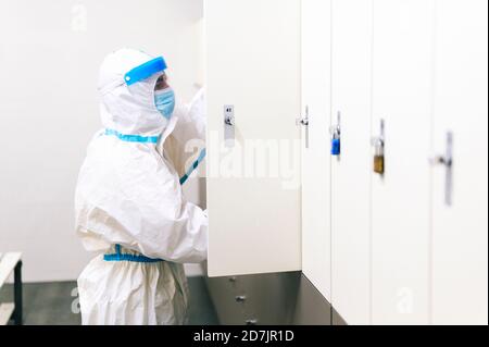 Mid adult man keeping bag inside locker at hospital Stock Photo
