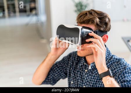 Architect using visual reality eyeglasses at office Stock Photo