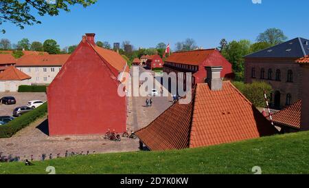 Copenhagen, Denmark - 04/29/2019: View of red painted military buildings in the center of the historic citadel Kastellet. Stock Photo