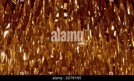 Closeup view of the golden shimmering sanded glass drop decoration of big luxury chandelier in a castle. Stock Photo