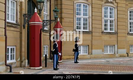Copenhagen, Denmark - 04/28/2019: Two members of the Royal Life Guards of Denmark (Den Kongelige Livgarde) guarding an entrance at Amalienborg castle. Stock Photo