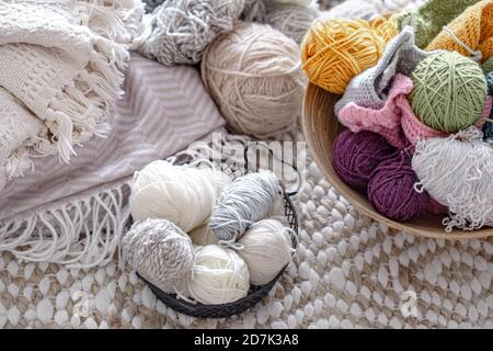 Multicolored balls of thread for knitting in the basket. Concept of Hobbies and crafts . Stock Photo