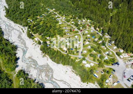 Drone shot,  Camp site in La Fouly, camping site is located in on a glacier moraine near a glacier river, Switzerland Stock Photo