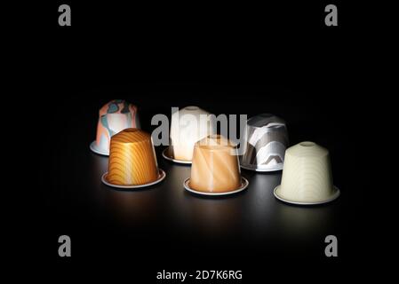 group of espresso capsules on dark background in low light Stock Photo