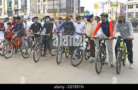 Beawar, India. 21st Oct, 2020. People ride bicycle and vehicles as they arrive to takes part in a awareness rally about Coronavirus pandemic in Beawar. (Photo by Sumit Saraswat/Pacific Press) Credit: Pacific Press Media Production Corp./Alamy Live News Stock Photo