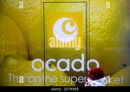 London, UK. 23rd Oct, 2020. A woman wearing a face covering walks past an Ocado's delivery van. Credit: Dinendra Haria/SOPA Images/ZUMA Wire/Alamy Live News Stock Photo
