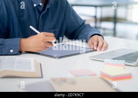 Using digital tablet for online learning and communication and working on digital tablet using stylus pen. Online communication concept. Stock Photo
