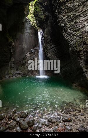 Slap Kozjak waterfall emerging into cave pool near Kobarid, Slovenia Stock Photo