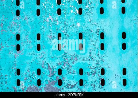 Old metal blue sheet with holes. Background, copy space Stock Photo