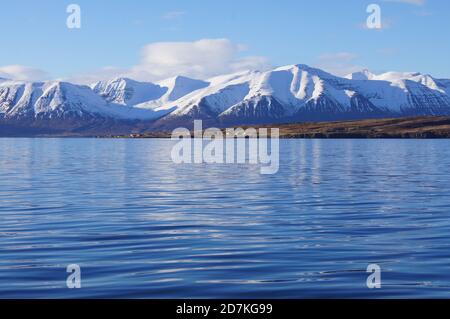 Snow Capped Mountains across the Eyjafjordur fjord near Akureyri , Northern Iceland Stock Photo