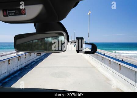 Looking through a dashcam car camera installed on a windshield with view of Venice Beach Pier, Los Angeles, California, USA Stock Photo