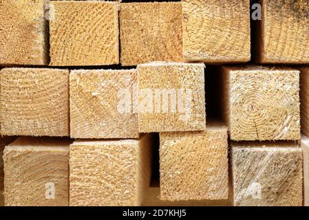 Lumber in sawmill, ends of timber blocks for texture background. Sawed and processed wood in storage, lumber stack in factory yard. Pile of wooden boa Stock Photo