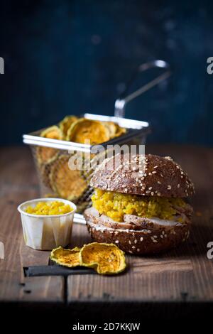 Gluten free Burger with sliced roast meat and cucumber relish, zucchini chips, selective focus Stock Photo