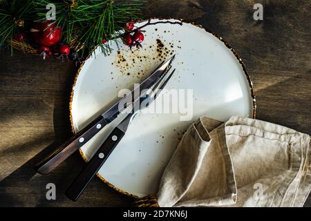 Minimalistic table setting for Christmas dinner on wooden table Stock Photo